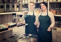 Two female sellers wearing apron Royalty Free Stock Photo