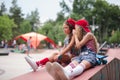 Two female skaters best friends hangout at the skate park on sunset .Laughing and fun.