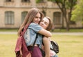 Two female student hug in university campus. Royalty Free Stock Photo