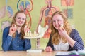 Two female students exploring jaw model with teeth in biology Royalty Free Stock Photo