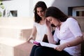 Two female students having a hard time, preparing for exams together outdoors Royalty Free Stock Photo