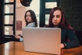 Two female students or lesbians having fun during coffee break at cafe, second half distract from work. Royalty Free Stock Photo