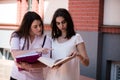 Two female students preparing for exams together outdoors Royalty Free Stock Photo