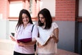 Two female students preparing for exams together outdoors on the campus Royalty Free Stock Photo