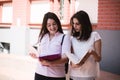 Two female students preparing for exams together outdoors on the campus Royalty Free Stock Photo