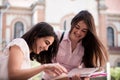 Two female students preparing for exams together outdoors Royalty Free Stock Photo