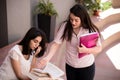 Two female students preparing for exams together outdoors Royalty Free Stock Photo