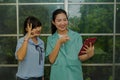 Two female teachers used sign language to communicate video conferences happily.