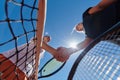 Two female tennis players shaking hands with smiles on a sunny day, exuding sportsmanship and friendship after a