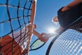 Two female tennis players shaking hands with smiles on a sunny day, exuding sportsmanship and friendship after a