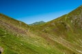 Two female trekkers with backpack. Woman hikers trekking in mountain ridge slopes of Rodna Mountains National Park multiday hike, Royalty Free Stock Photo