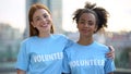 Two female volunteers smiling on camera, high school charity program, altruism Royalty Free Stock Photo