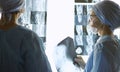 Two female women medical doctors looking at x-rays in a hospital