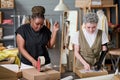 Two female workers of warehouse packing and sealing with cellotape parcels Royalty Free Stock Photo