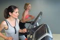 Two females riding stationary bicycles in modern club for women Royalty Free Stock Photo