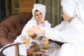Cheerful women in white robes after spa treatments Royalty Free Stock Photo