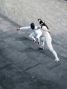 Two fencers fencing outside together Royalty Free Stock Photo