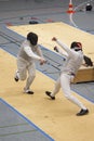 Two fencers fencing for the victory Royalty Free Stock Photo