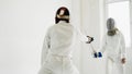 Two fencers having training attack exercises in fencing in studio