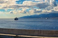 Two ferryboats in the canal of Messina on the background the city`s skyline. Messina. Sicily. Italy