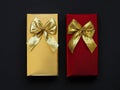 Two festive gift boxes of chocolates on a black background