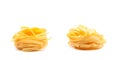 Two fettuccini pasta nests isolated on white. Royalty Free Stock Photo