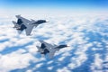 Two fighters jet in the sky at high speed flying a combat mission against the background of clouds Royalty Free Stock Photo