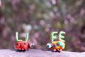 Two figures of ladybirds made of plasticine. Next to it is the inscription life Royalty Free Stock Photo