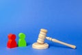 Two figures of people opponents stand near the judge`s gavel. The judicial system. Court case, settling disputes. Legal advice Royalty Free Stock Photo
