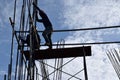 Two Filipino Construction steel workers assembling steel bars on high-rise building with no proper protective suits and safety sho