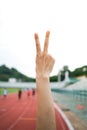 Two fingers victory peace sign from the perspective of the person who makes the sign