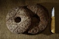 Two finnish traditional round ray bread on sackcloth and knife p