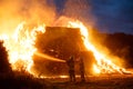 Two firefighters putting out fire on a haystack. Hertfordshire. UK. Royalty Free Stock Photo