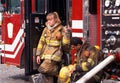 Two firefighters take a break after fighting a house fire