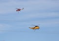 Red and Yellow Fire Helicopters Pass Each Other in Fire Fight