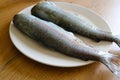 Two fish are on a plate in the kitchen Royalty Free Stock Photo