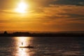 Two fisherman fishing on the lake at sunset Royalty Free Stock Photo