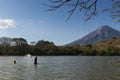 Two fisherman fishing in the shores of the Ometepe Island in Lake Nicaragua, with the Concepcion Volcano on the background