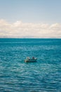 Two fishermen on a boat in Amantani Island, Titicaca Lake, Peru