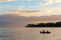 Two fishermen in a boat going fishing early in the morning at dawn Royalty Free Stock Photo