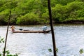 Two fishermen in a canoe navigating the Jaguaripe River