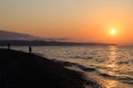 Two fishermen catch fish on the beach at dawn Royalty Free Stock Photo