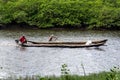 Two fishermen, each in their canoe, sailing on Jaguaripe river