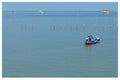 Two fishermen fishing from a traditional long tail boat near the Port of Surat Thani in Thailand Royalty Free Stock Photo