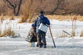 Two fishermen on the ice of the lake. Ice winter fishing Royalty Free Stock Photo