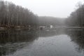 Two fishermen on the ice of a recently frozen pond Royalty Free Stock Photo