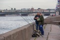 Two fishermen at the Neva river in St. Petersburg