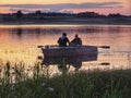 Fishermen returning at sunset Volgo Lake Russia