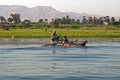 Two fishermen are in a small boat on the Nile river, Egypt Royalty Free Stock Photo