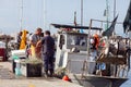 Two Fishermen standing near their fishing trawler. Trieste, Italy Royalty Free Stock Photo